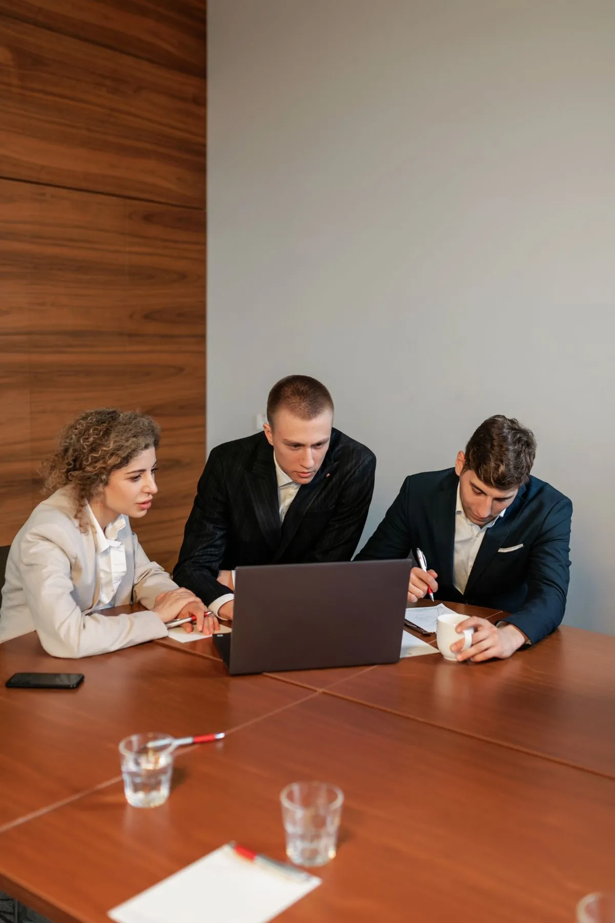Professionals reviewing sourcing options in a meeting
