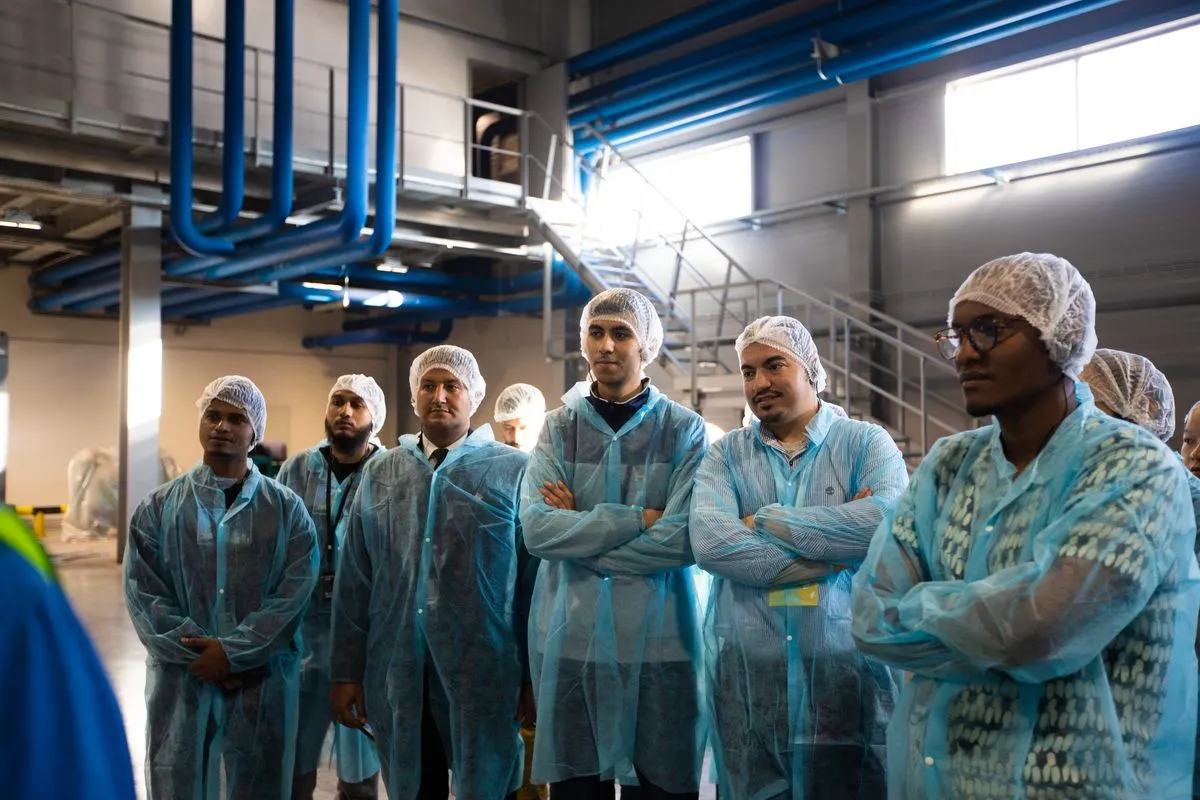 Visitors in protective clothing on a factory tour